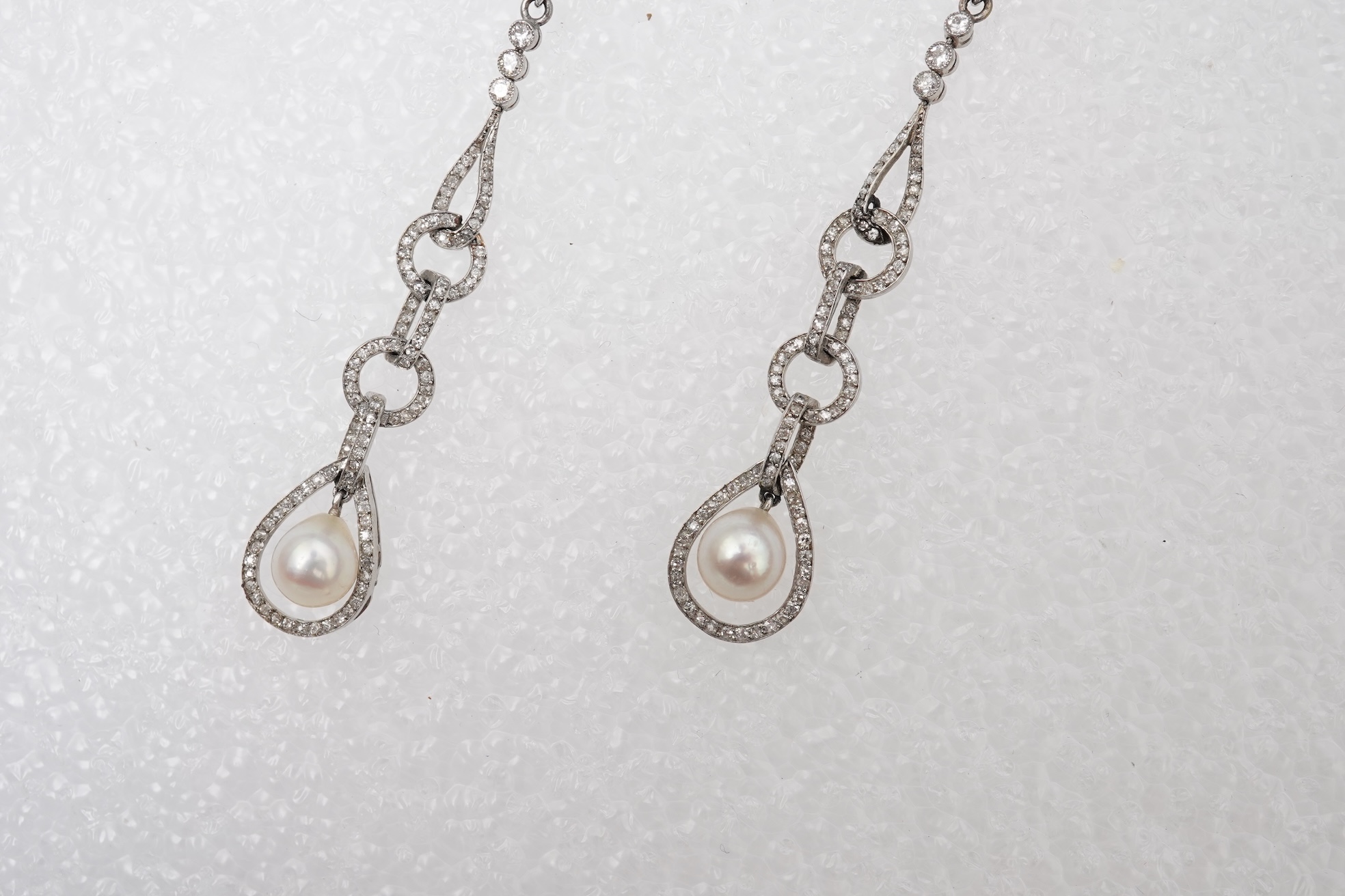 Attributed to Maurice Robin & Cie, a fine and rare pair of Art Deco natural pearl and diamond earrings, Paris, circa 1920